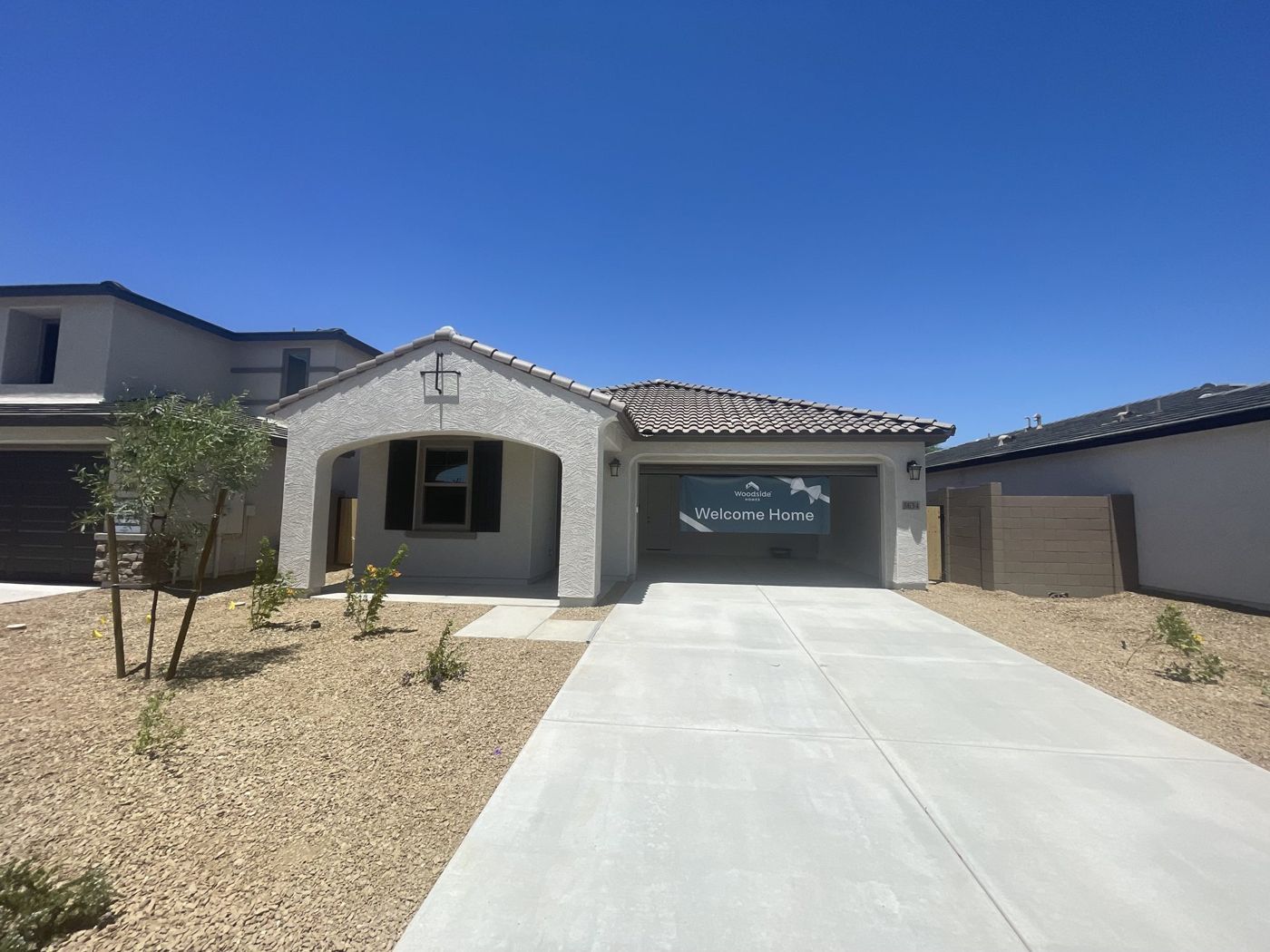 Newly built single-story home with fresh desert landscaping