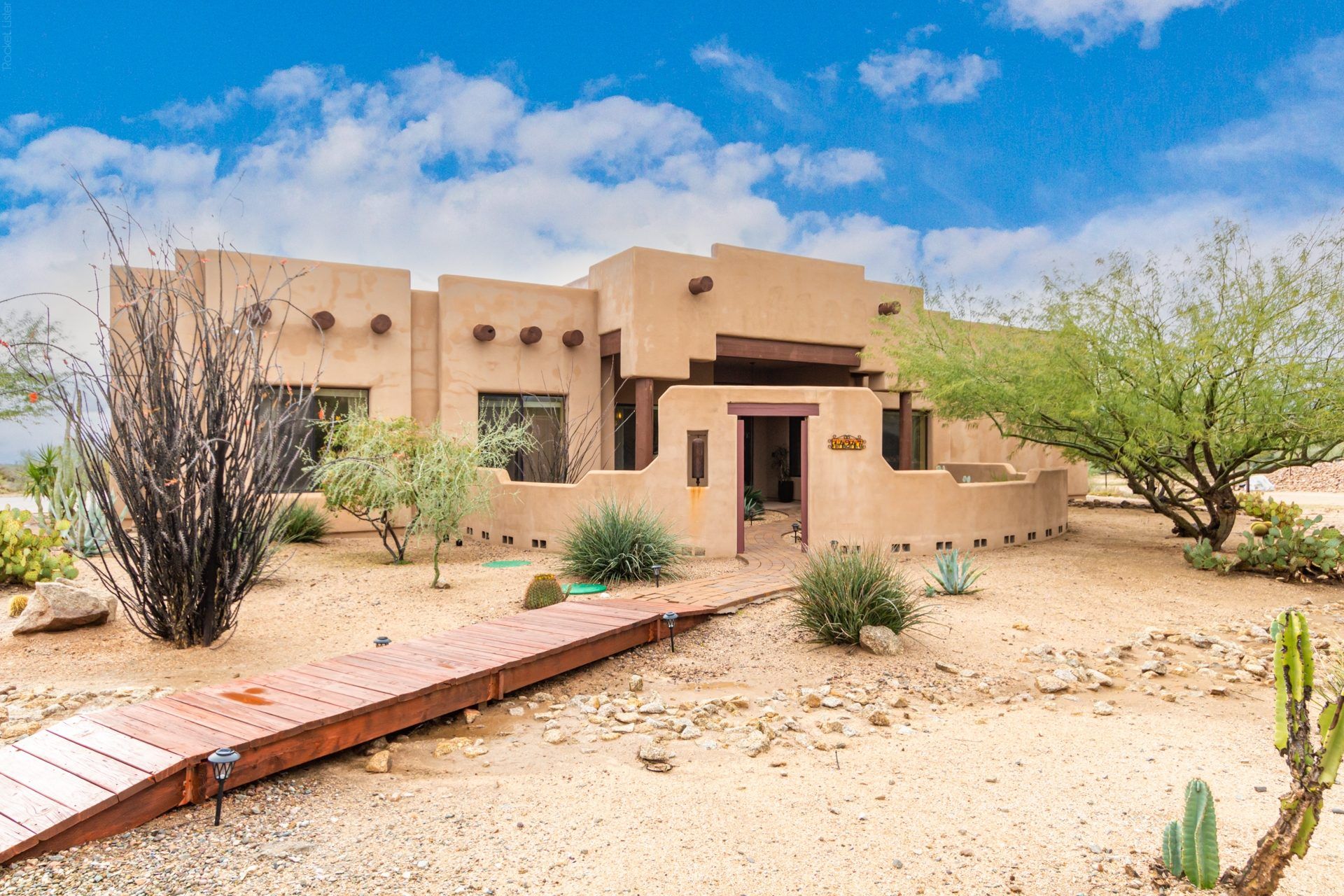 Desert-style home with a stucco exterior and native landscaping