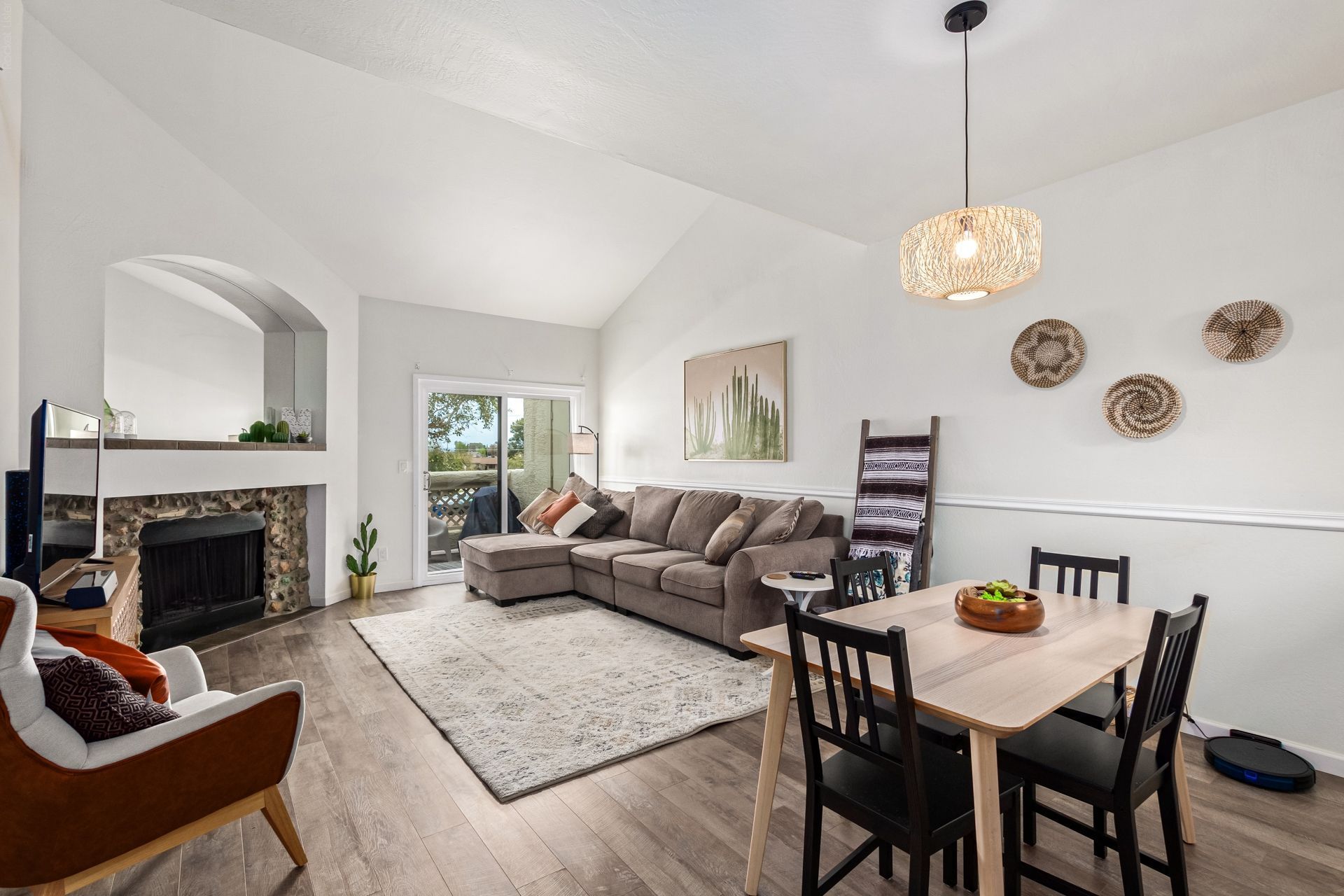 Condo living room with a fireplace and vaulted ceiling